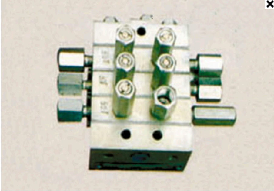 Distributor block bodies — front and back views