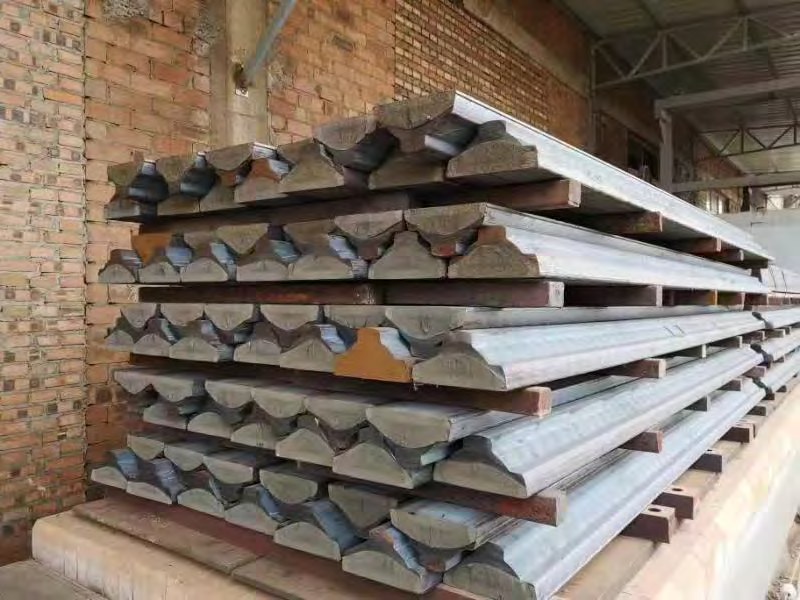 Racks of round and semicircular continuous cast iron bar profiles in the bar yard