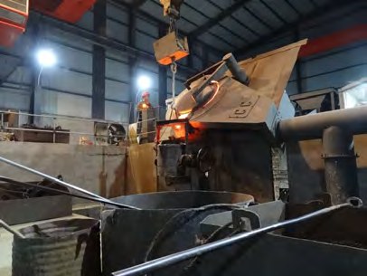 Operator tapping the holding furnace of the continuous casting machine