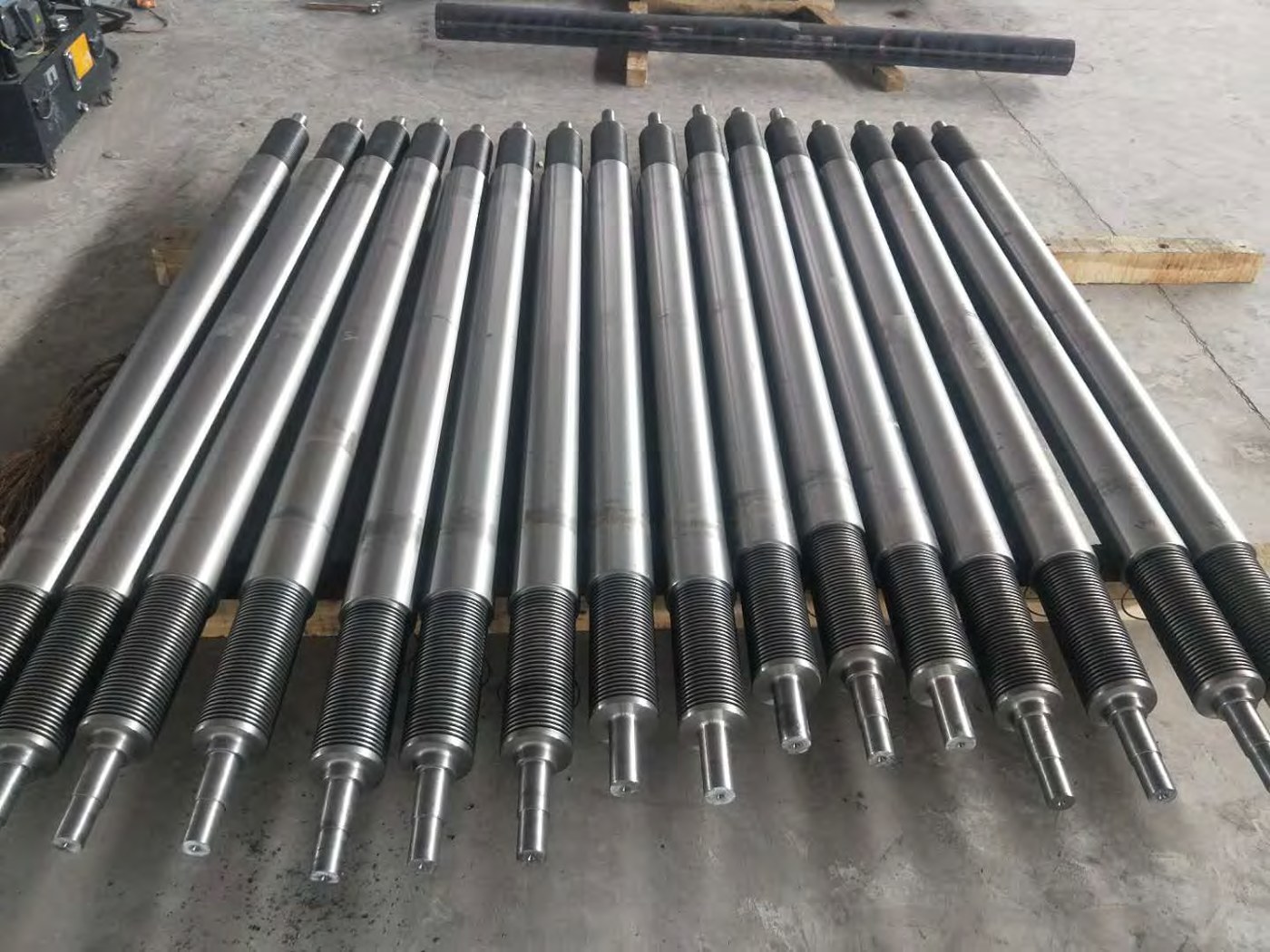 Row of precision CNC machined shafts produced from continuous cast iron bar